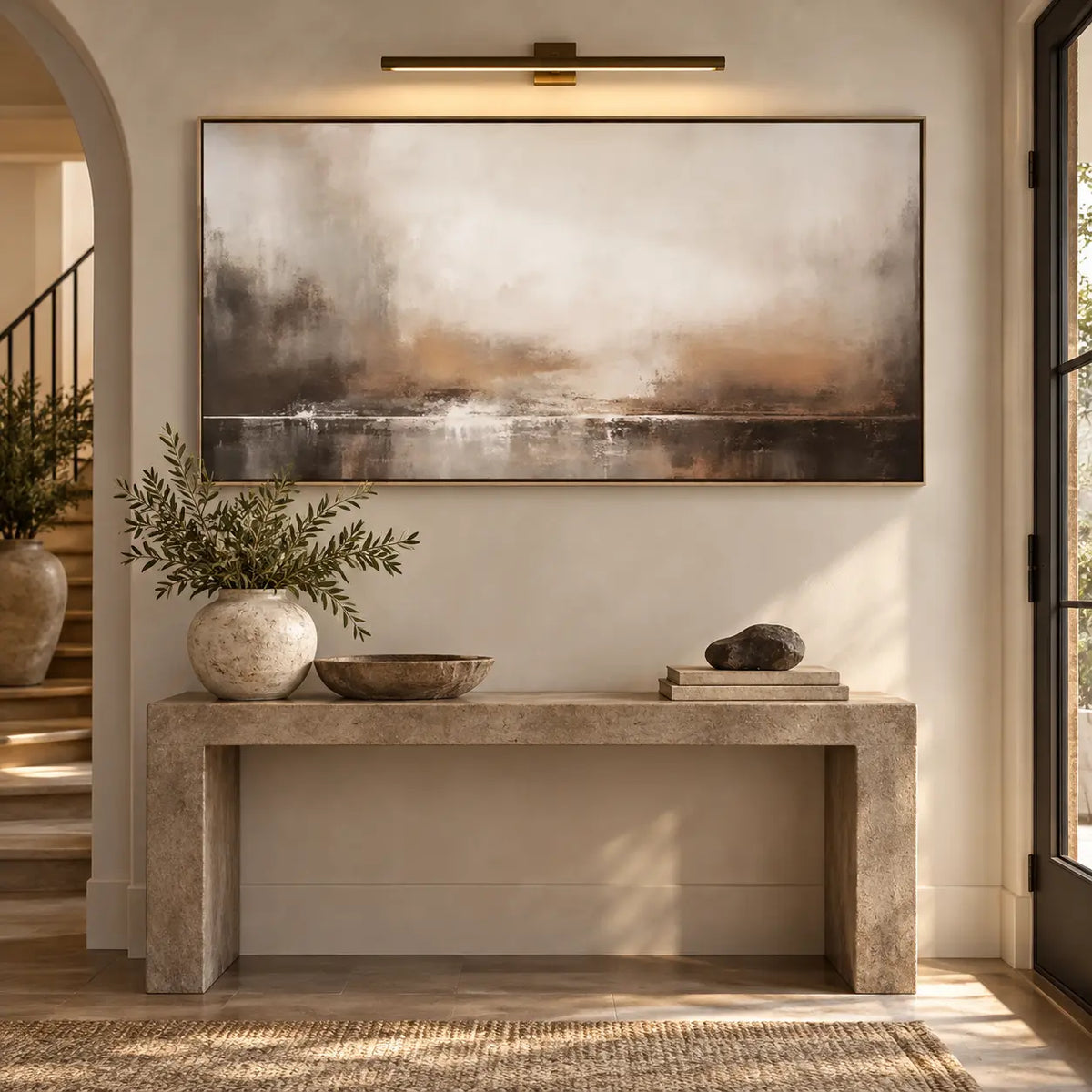 A Quiet Line of Light: above a stone console beneath a brass picture light