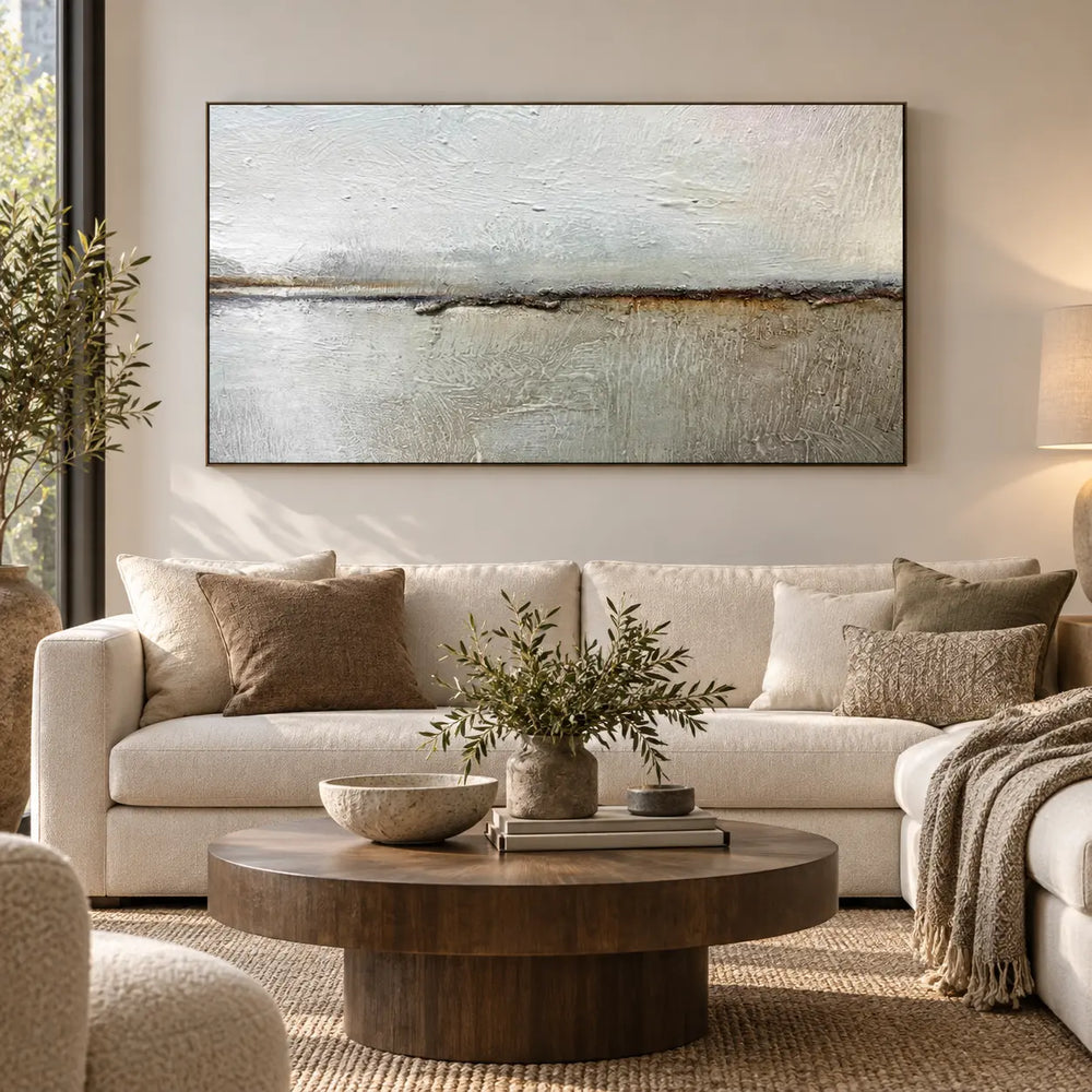 An Ochre Line in the Mist: above a cream sofa with a round wood table and leafy vase