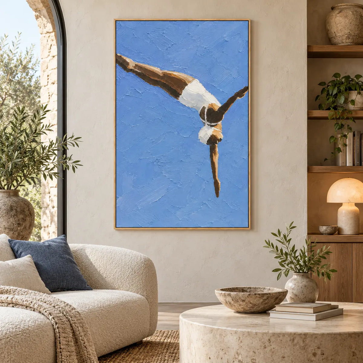 Arc into Blue beside a curved cream sofa near an arched window and open shelves