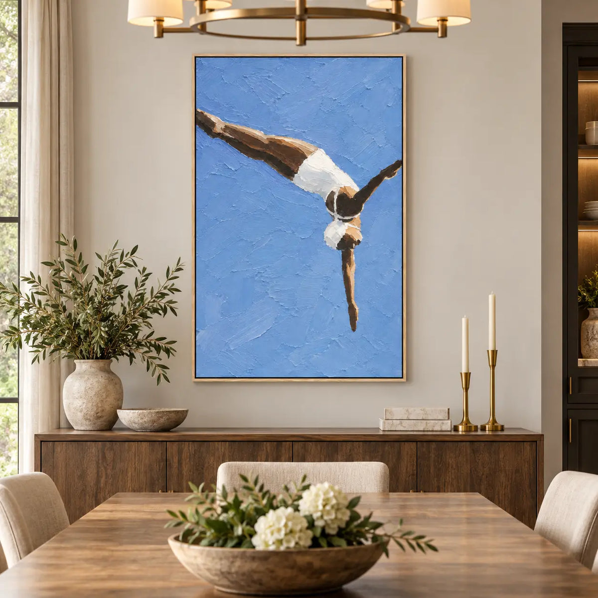 Arc into Blue over a dining sideboard beneath a brass chandelier and beside candles