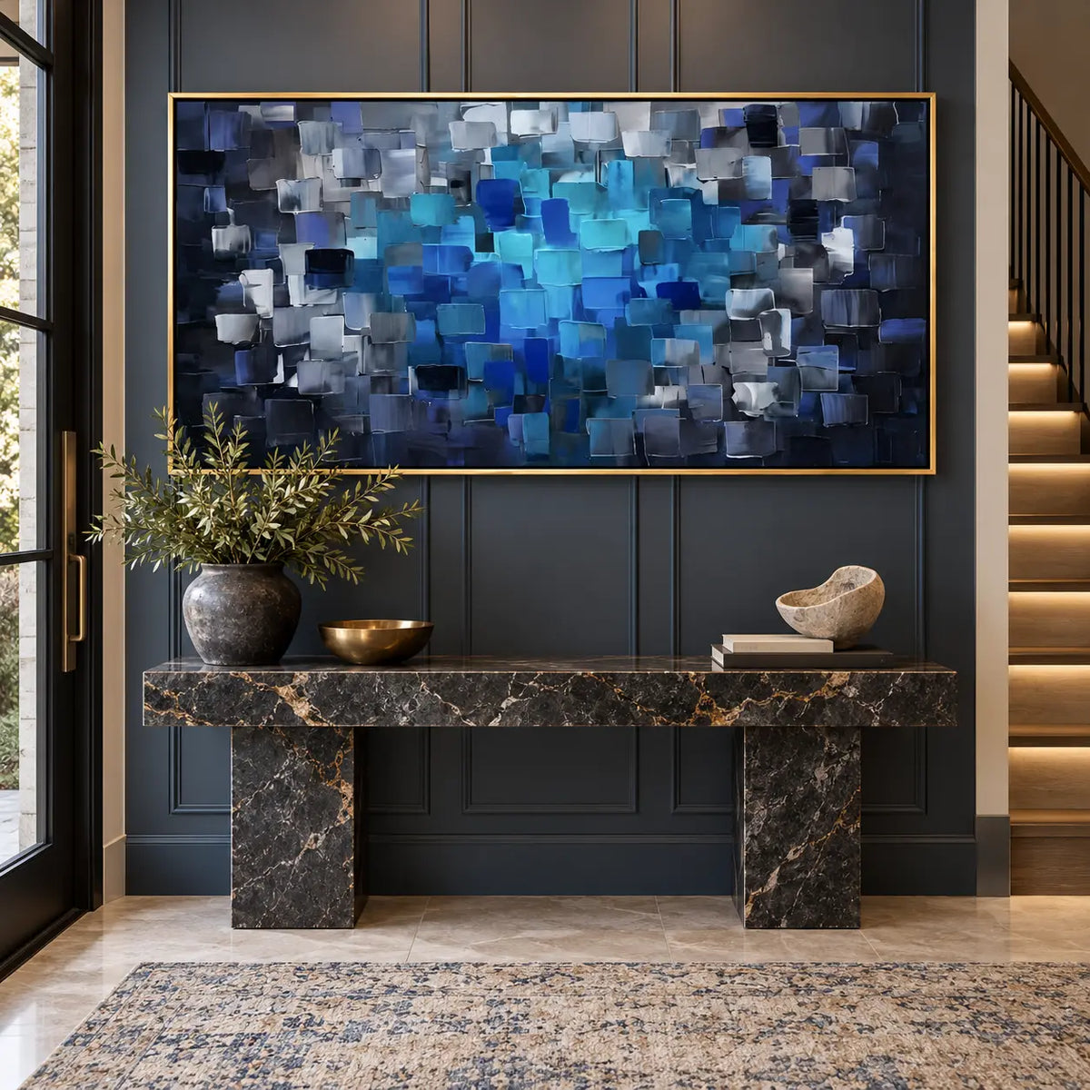 Azure at the Center: above a black marble console against blue paneling beside lit stairs
