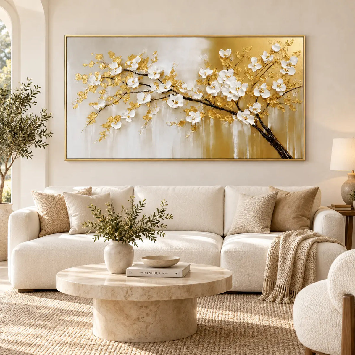 Blossoms on a Golden Bough: above a white sofa with tan cushions and a round stone coffee table