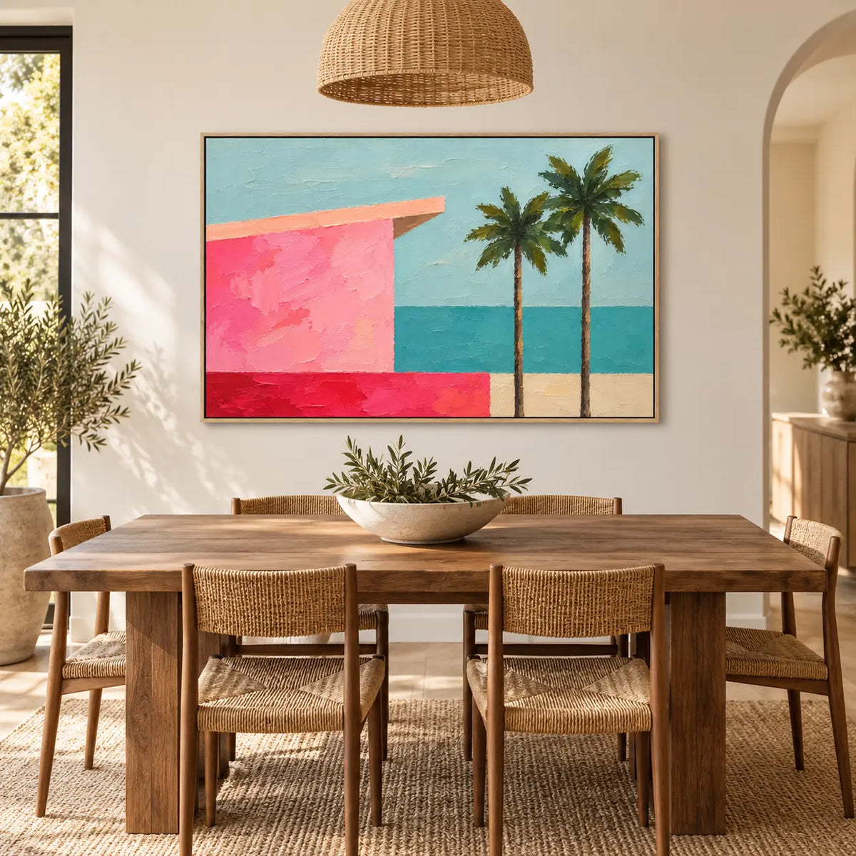 Coral Shore Pavilion above a dining table beneath a woven pendant with cane chairs