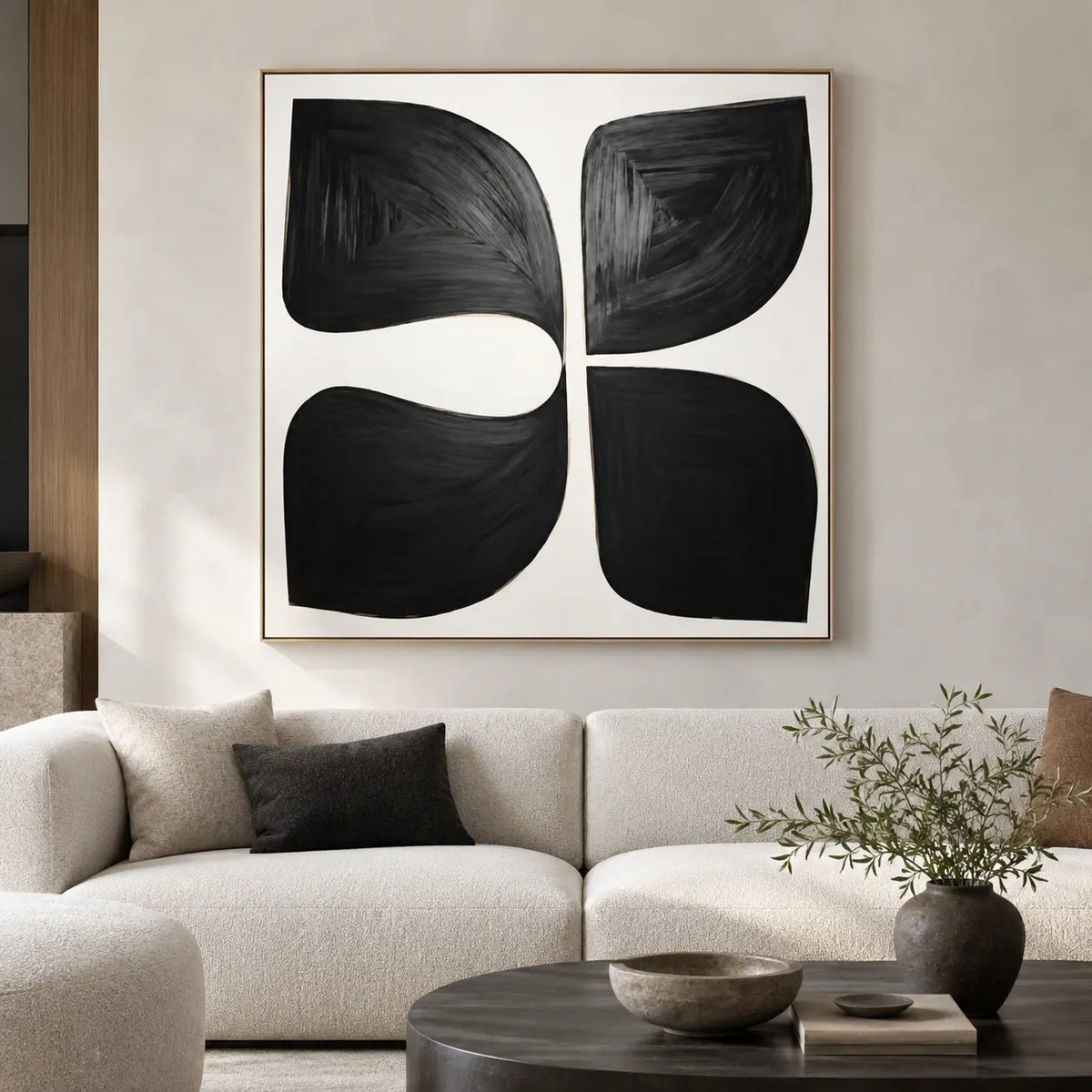 Four Forms Around a Pause: above a cream sofa with a black lumbar cushion and dark round table