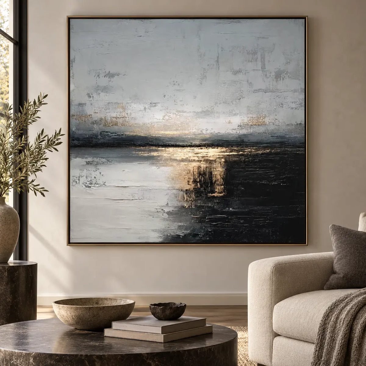 Gold at the Dark Waterline: beside a cream armchair with a charcoal throw and dark round table