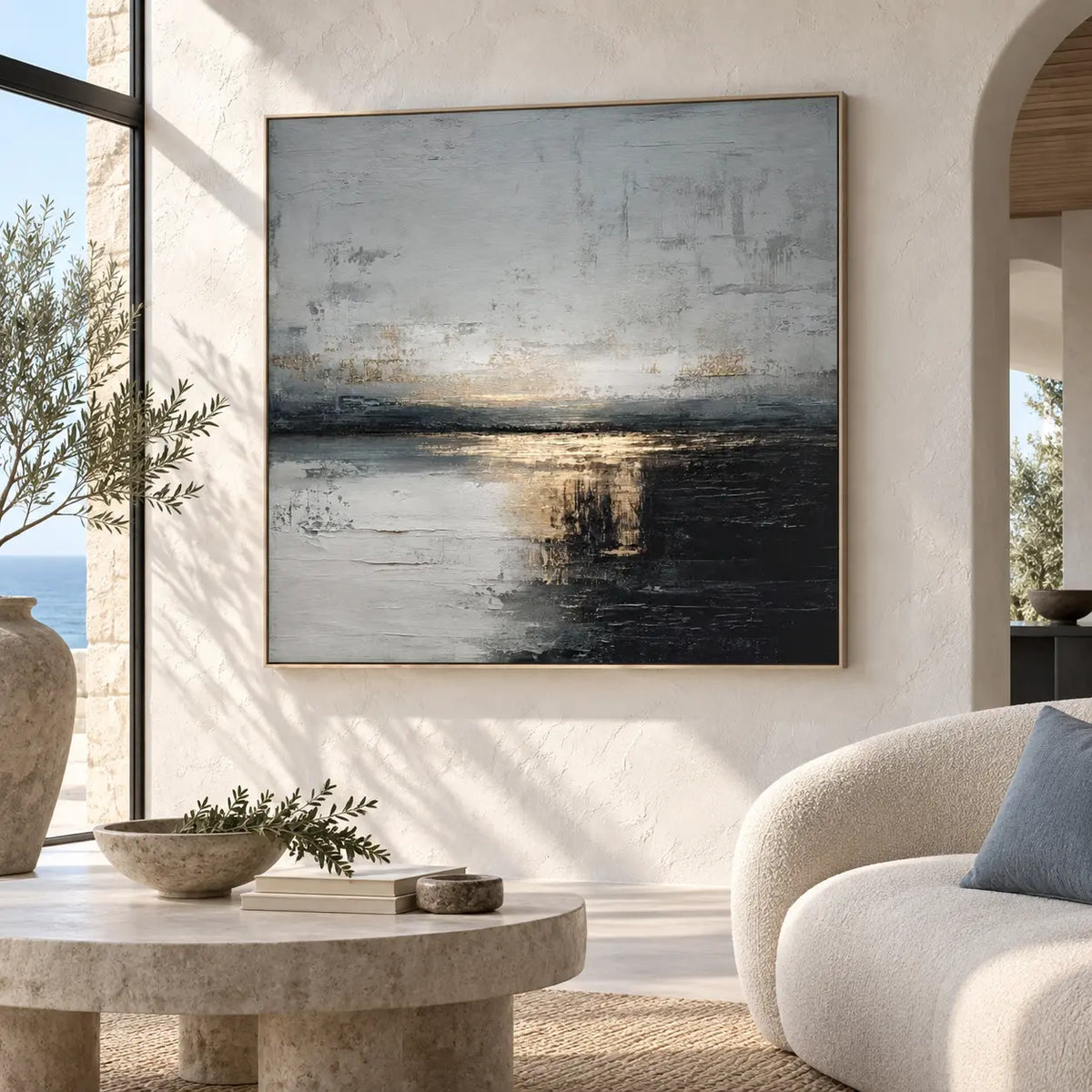 Gold at the Dark Waterline: beside a curved cream sofa with a blue cushion and sea-view window