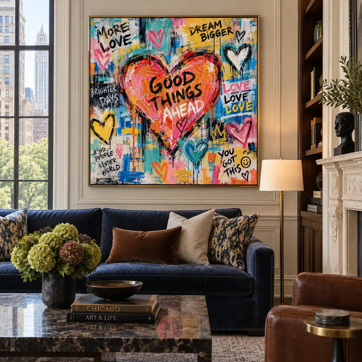 Good Things in a Coral Heart: artwork above a navy sofa on pale paneling beside a floor lamp