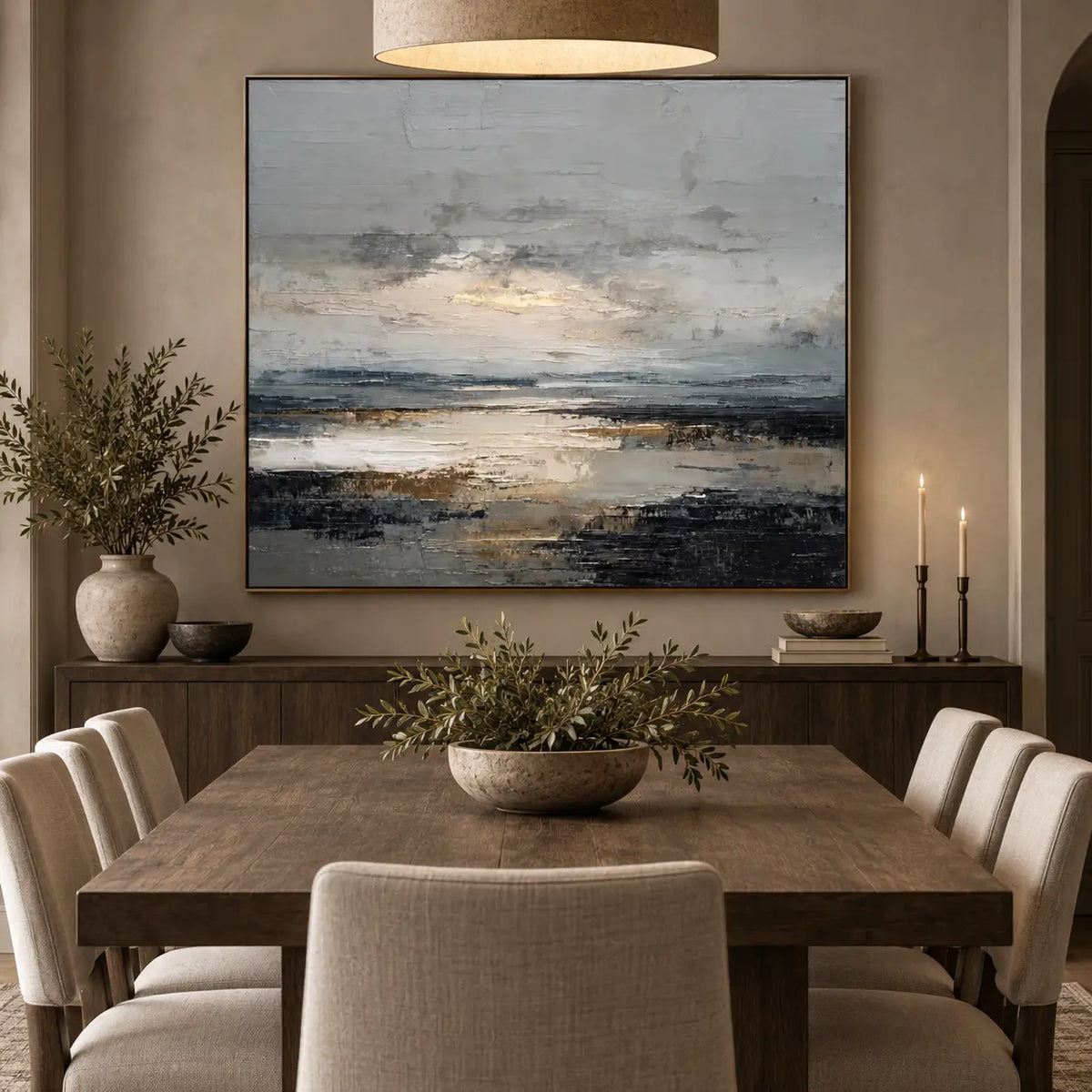 Light Between the Tidal Rocks: behind a wood dining table with cream chairs and two candlesticks