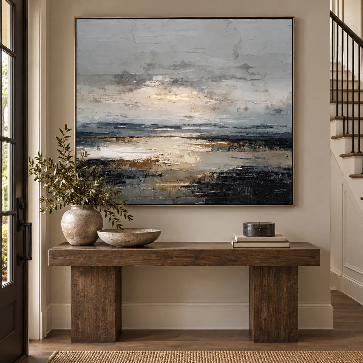 Light Between the Tidal Rocks: above a wood entrance console beside a black glass door and staircase