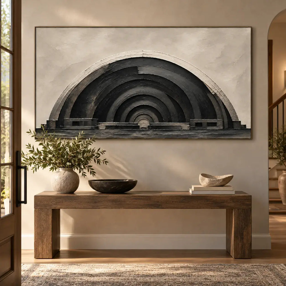 The Charcoal Arcade: above a wood console with a cream branch vase beside an arched passage