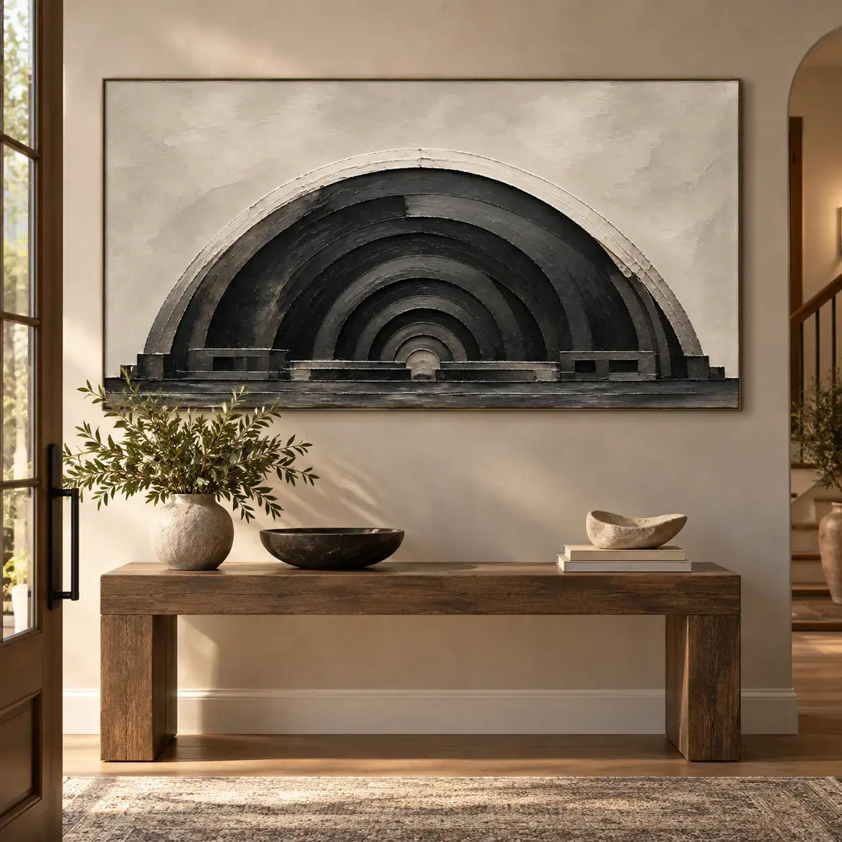 The Charcoal Arcade: above a wood console with a cream branch vase beside an arched passage