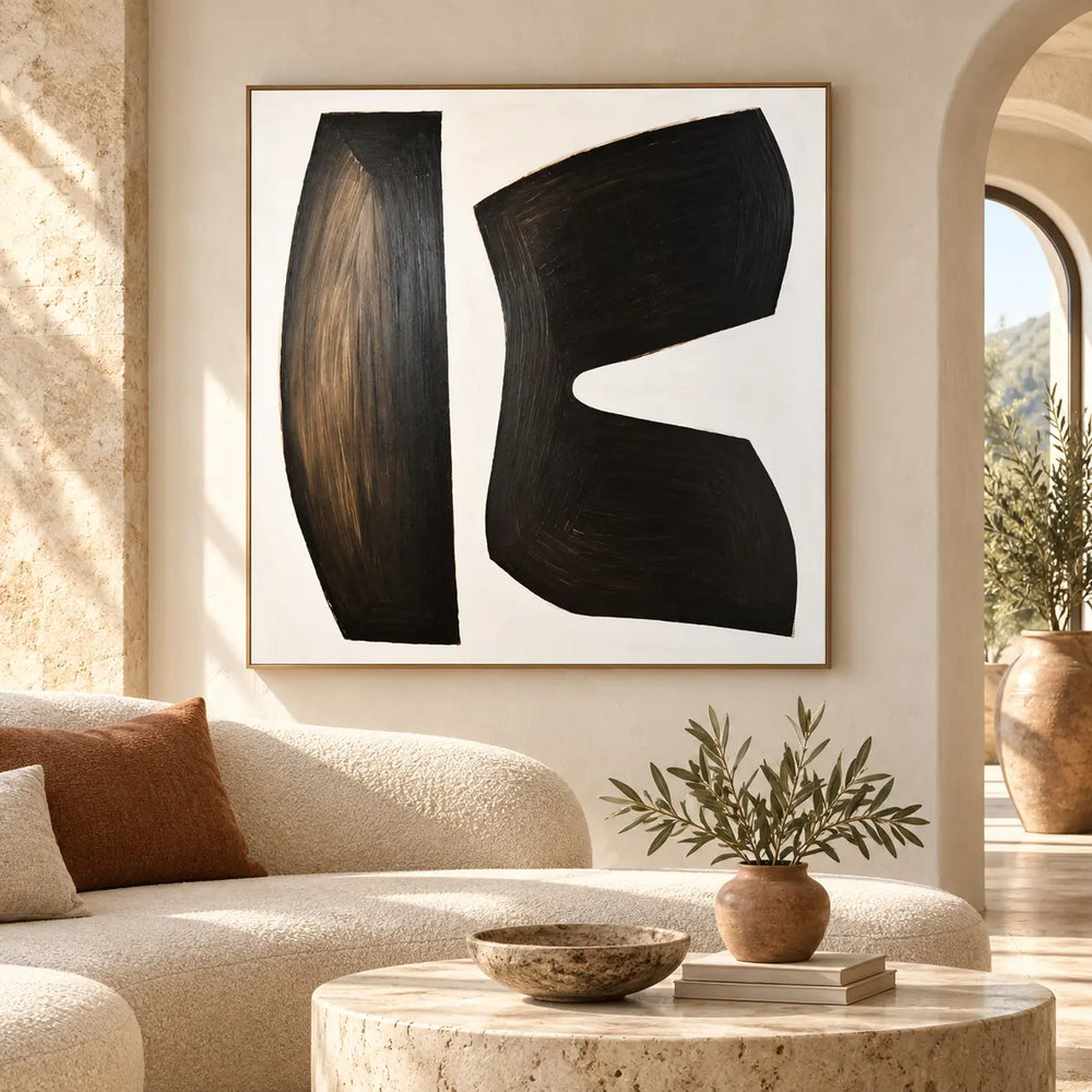 The Space Between Forms: above a curved ivory sofa beside a sunlit archway