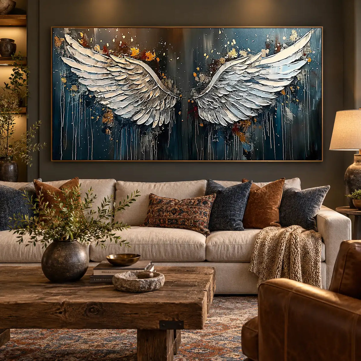 The Unfolding of Wings: over a cream sofa with blue and rust cushions beside a lamp