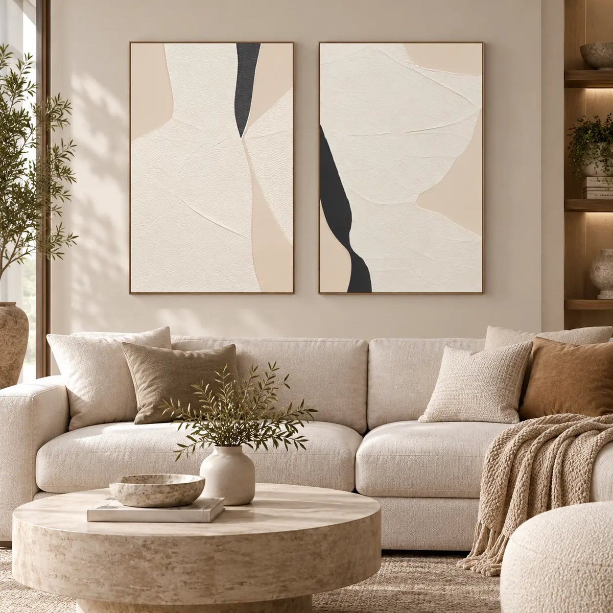 Two Openings in Cream: paired above a cream sofa with tan cushions and a round stone table