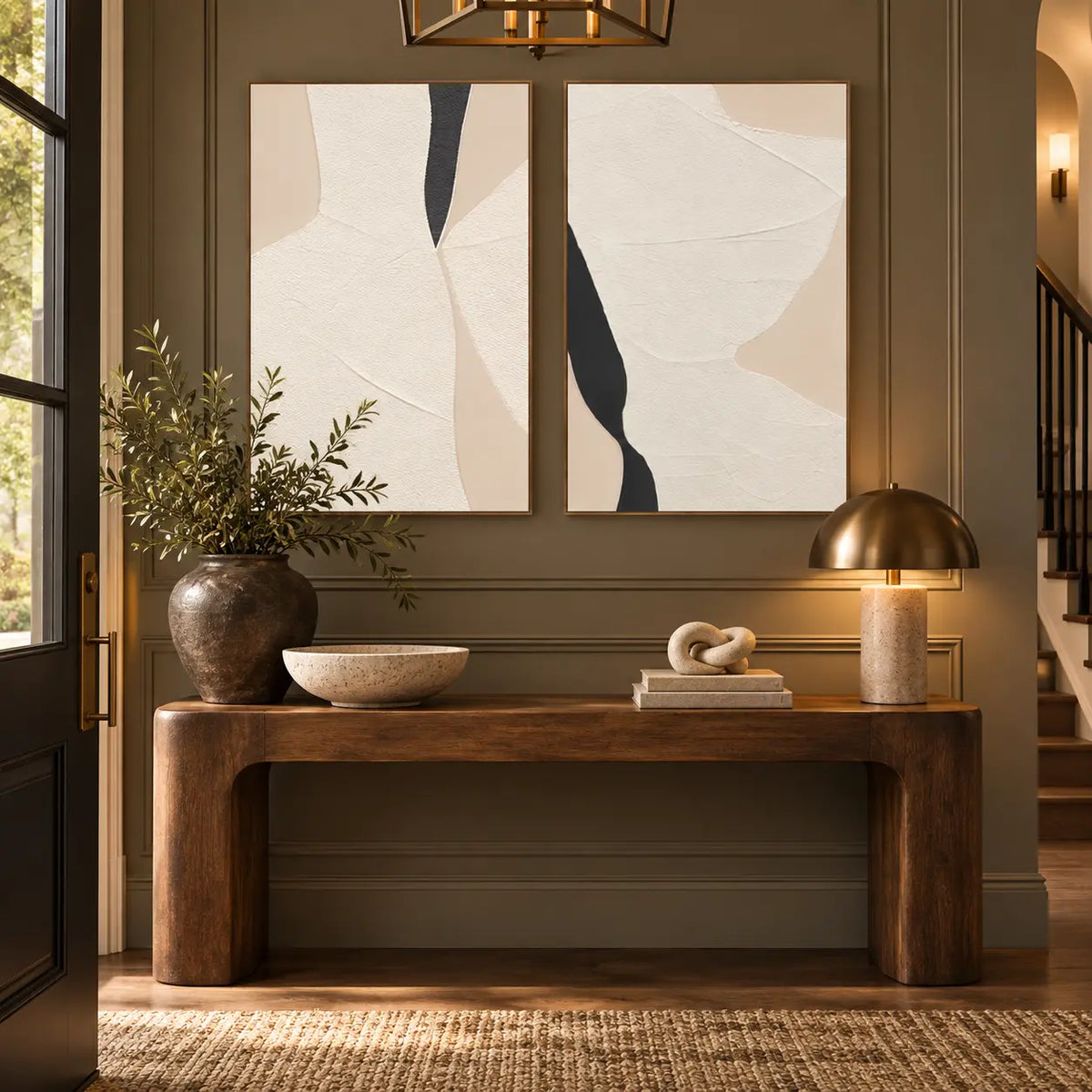 Two Openings in Cream: paired above a wood entrance console with a brass dome lamp