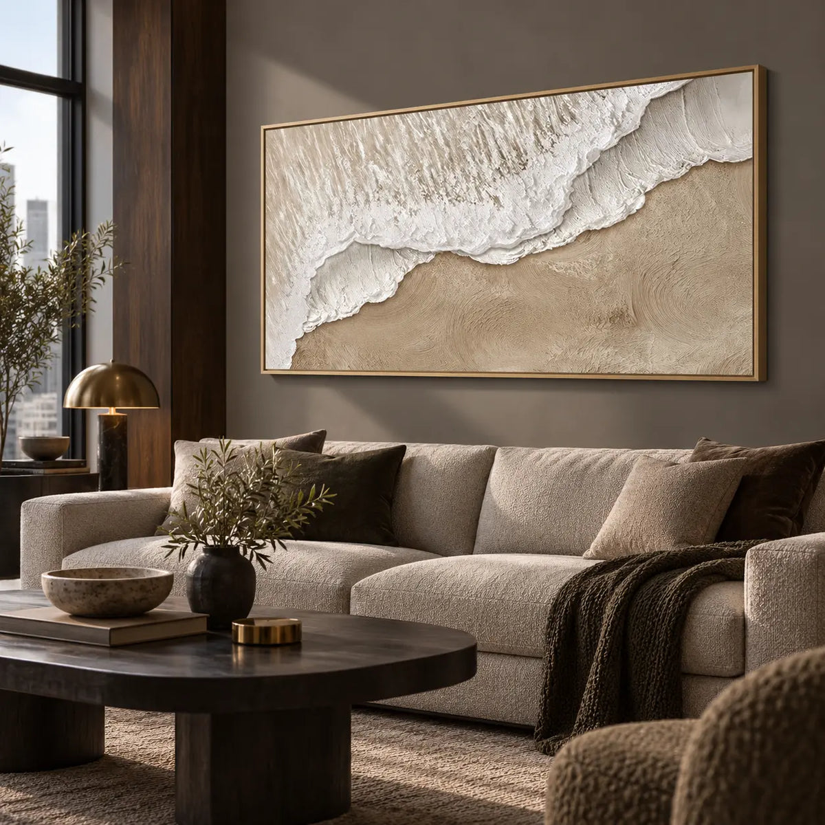 Where Foam Meets Sand: above a cream sofa with dark cushions and a dark round table