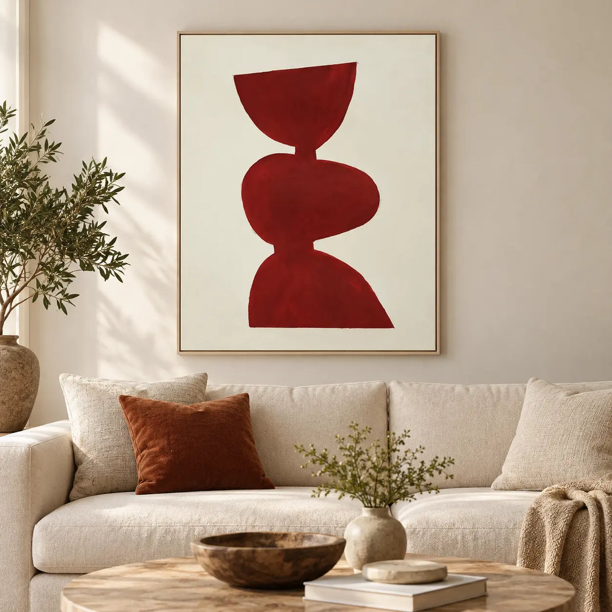 A Balance in Vermilion: above a cream sofa with a rust cushion and round stone table