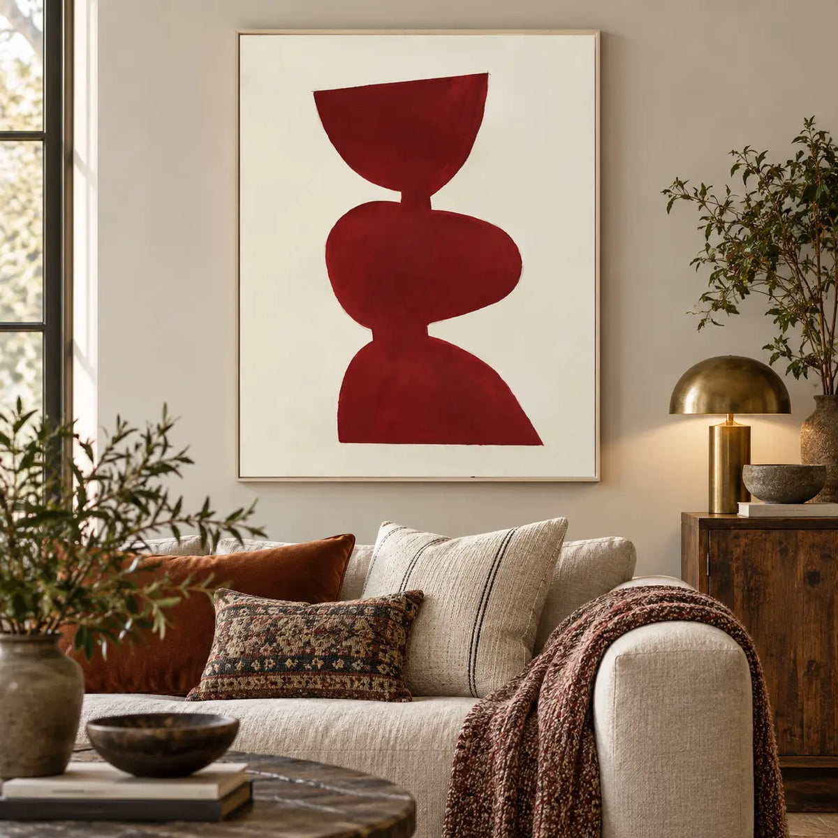 A Balance in Vermilion: above a cream sofa with patterned cushions and a burgundy throw