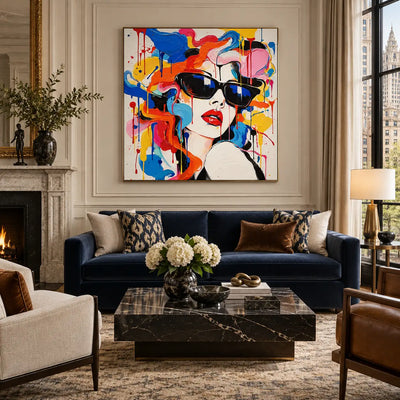 A Glance Through Color: artwork above a navy sofa beside a pale fireplace and floor lamp