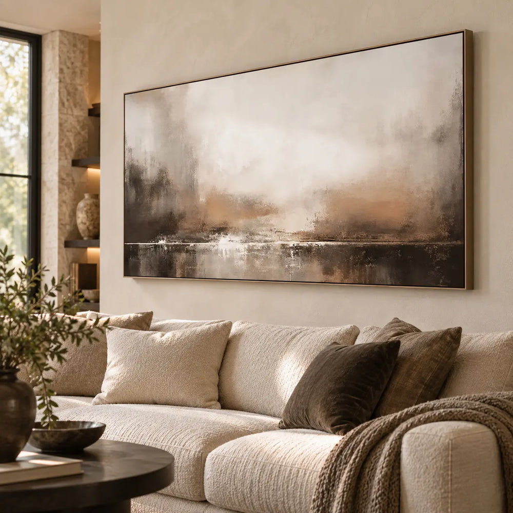 A Quiet Line of Light: seen obliquely above a cream sectional beside stone shelving