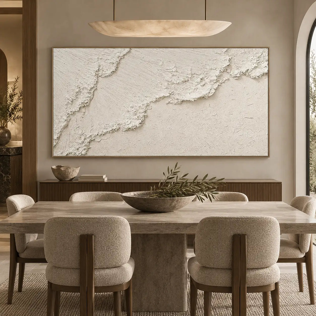 A Ridge Across Silence: behind a stone dining table beneath an oval pendant light