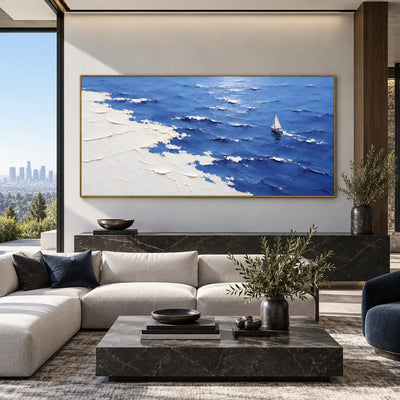 A Sail Beyond the White Margin: above a pale sectional with navy cushions and a black marble table