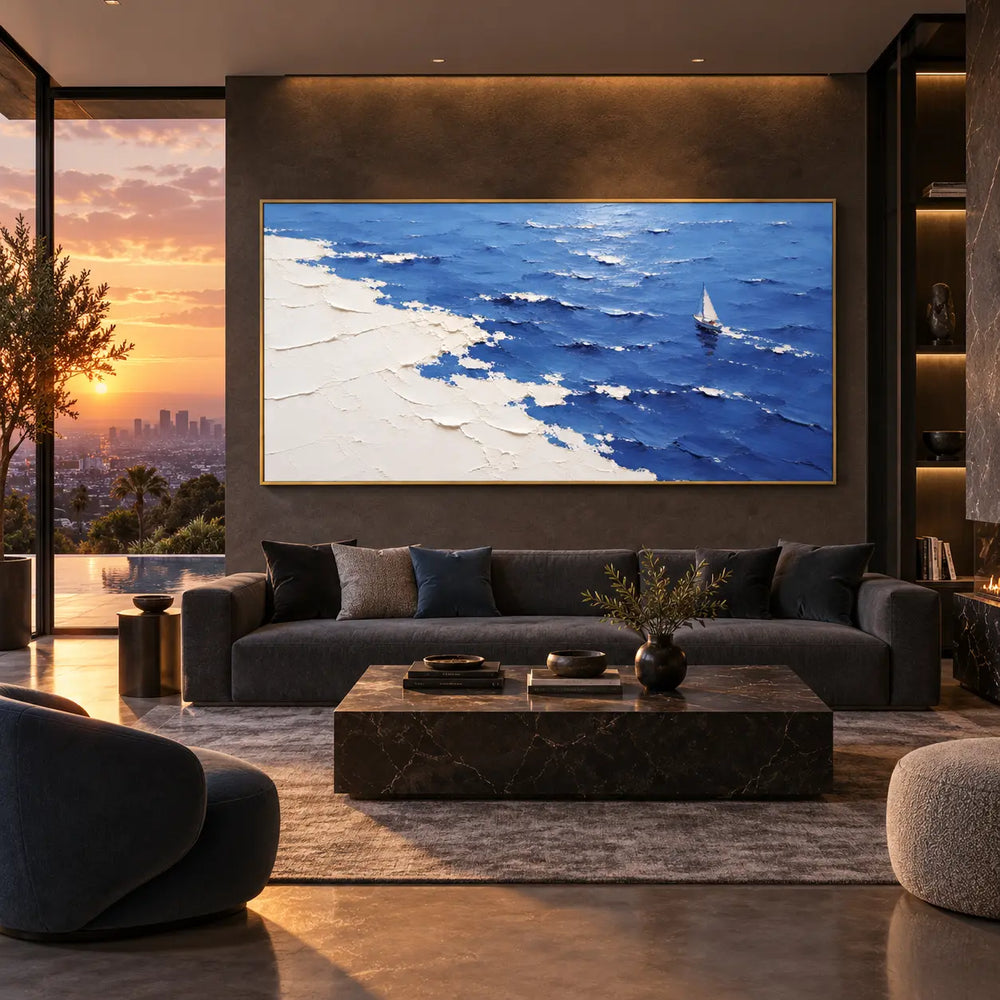 A Sail Beyond the White Margin: above a dark sofa beside sunset glazing and illuminated shelving