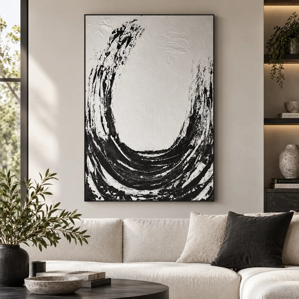 An Arc Left Open: above a cream sofa with a black cushion and dark round table beside lit recessed shelves