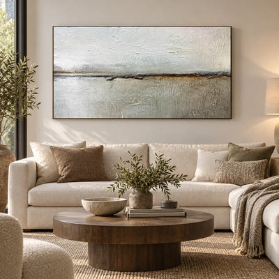 An Ochre Line in the Mist: above a cream sofa with a round wood table and leafy vase
