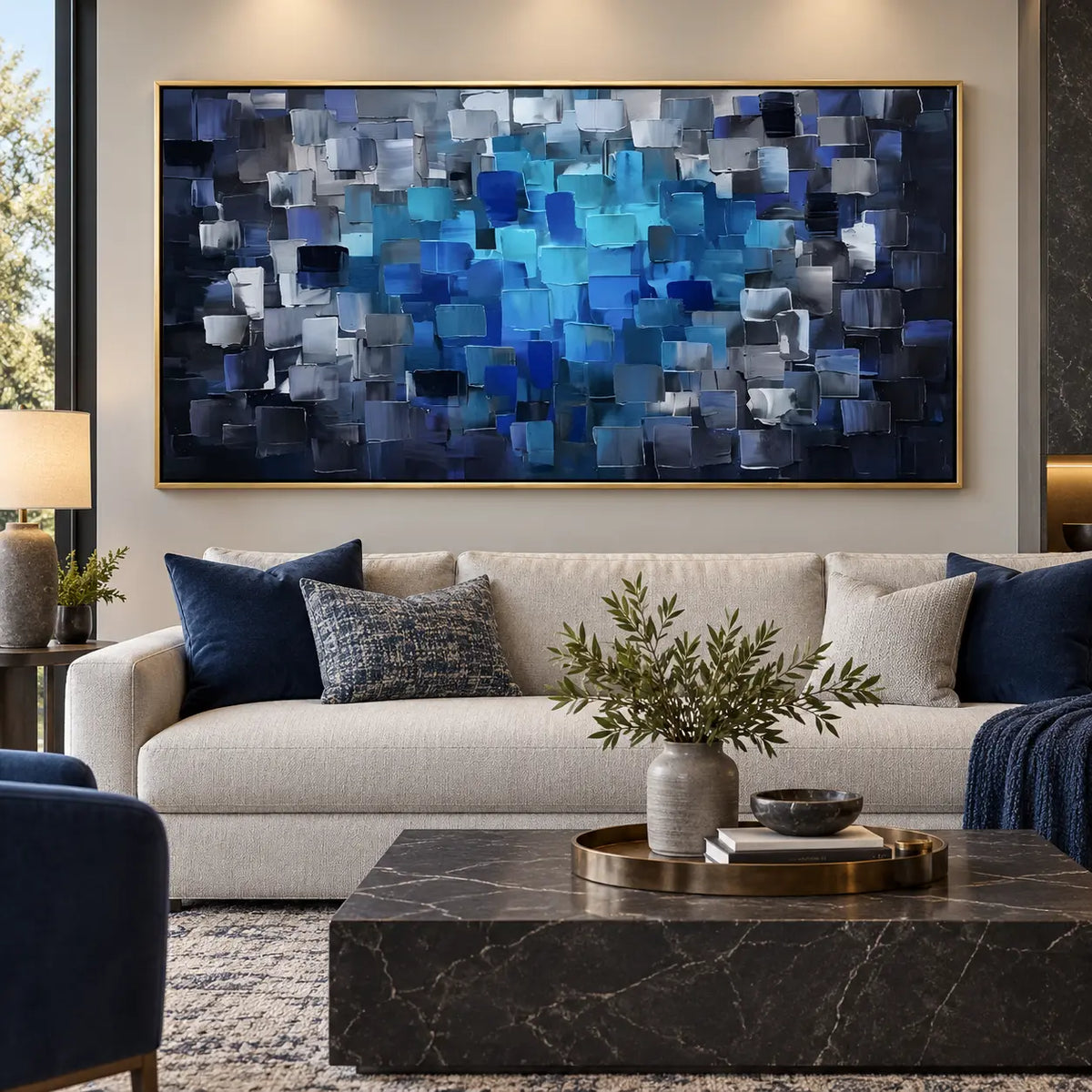 Azure at the Center: over an ivory sofa with blue cushions and a black marble table