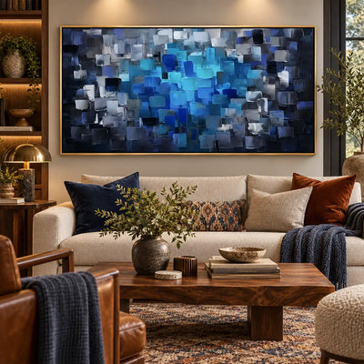 Azure at the Center: over a cream sofa beside illuminated wood shelves and a brass lamp