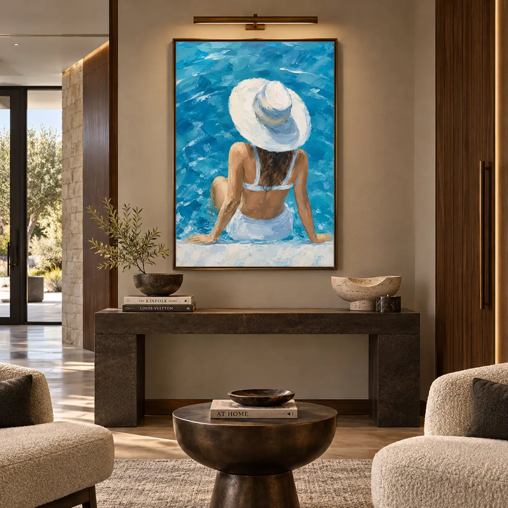 Beneath a Sunhat Brim: above a stone console beneath a picture light between rounded chairs