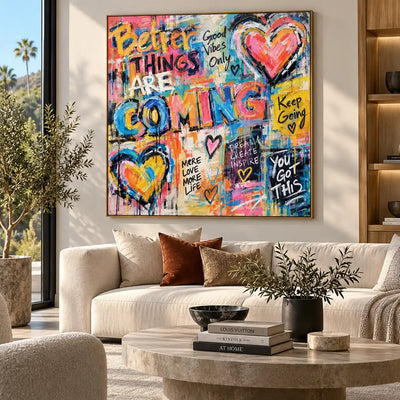 Better Things in Bright Letters: artwork above cream seating and a pale round stone coffee table