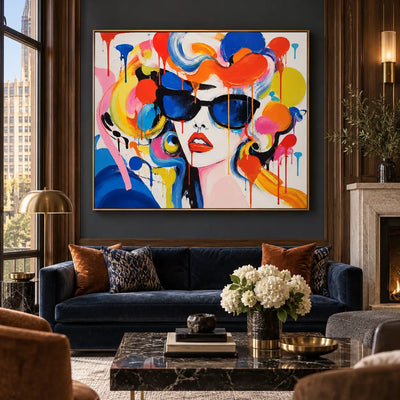 Blue Lenses and Tangerine Curls: artwork above a navy sofa on a charcoal wall beside a fireplace
