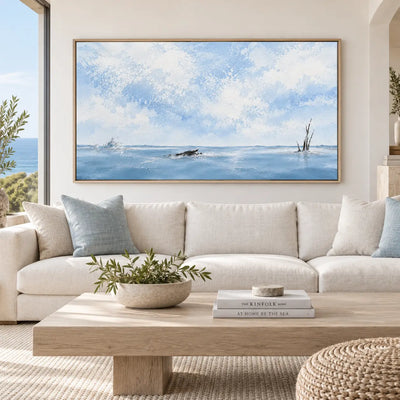 Branches in the Winter Expanse: above a cream sectional and light wooden table with blue cushions