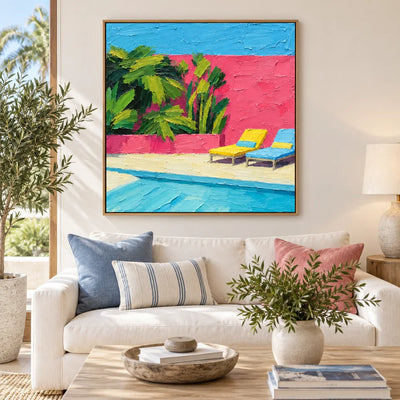 Coral Courtyard Pause above a white sofa with blue cushions beside a coastal window