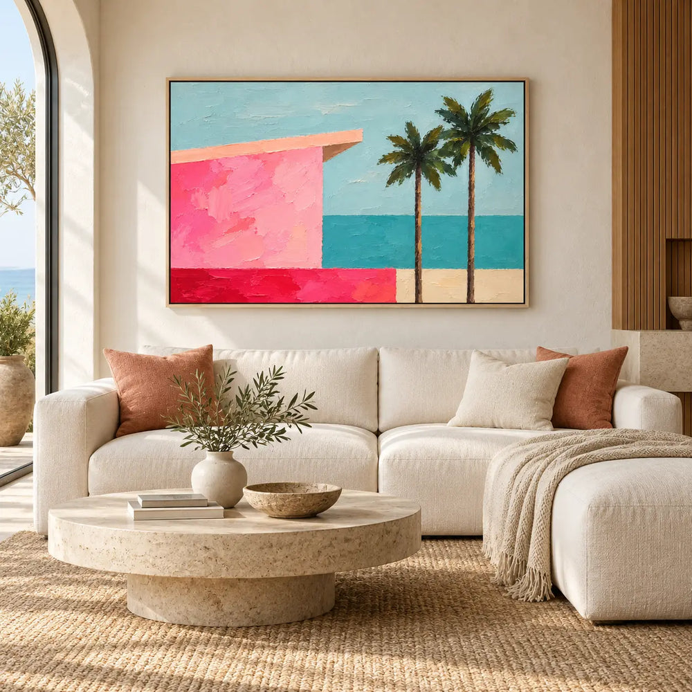 Coral Shore Pavilion above a curved ivory sofa with pink cushions and a stone coffee table