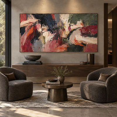 Crosscurrents of Rust and Ivory: above a low console between rounded gray chairs and a brass round table