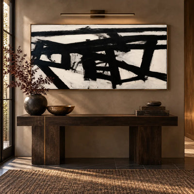 Crossing the Ivory Field: above a dark console beneath a slim brass picture light