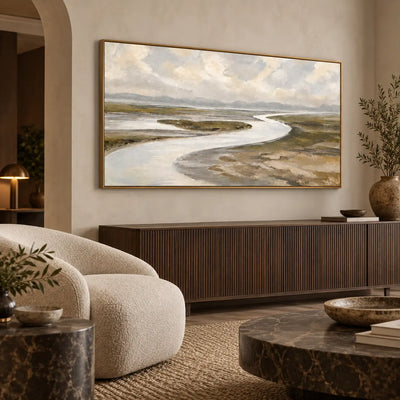 Estuary in Soft Weather over a dark slatted sideboard beside a rounded lounge chair
