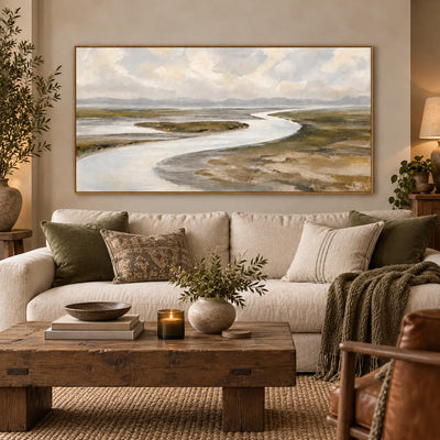 Estuary in Soft Weather above a sofa with neutral patterned cushions in a warm living room