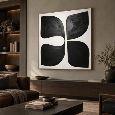Four Forms Around a Pause: above a long dark wood cabinet beside a brown leather sofa and lit bookshelves
