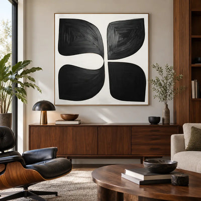 Four Forms Around a Pause: above a walnut sideboard beside a black leather lounge chair and dome lamp