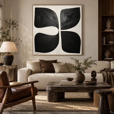 Four Forms Around a Pause: above a cream sofa with a brown cushion beside a rustic rectangular table and leather chair