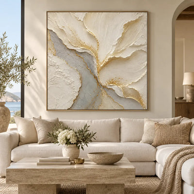 Gilded Faultlines: above a cream sofa with a stone coffee table and coastal window