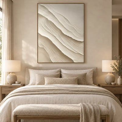 Ivory Folds Descending: above a beige bed with a cream upholstered bench and matching lamps