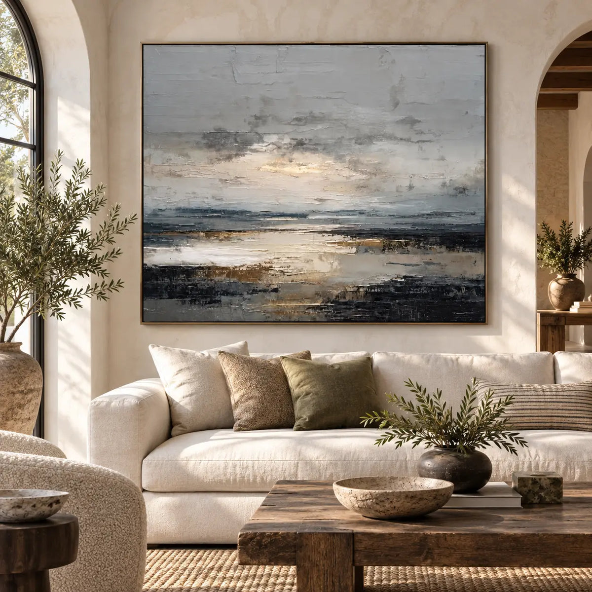 Light Between the Tidal Rocks: above a cream sofa between arched openings with a rustic wood table
