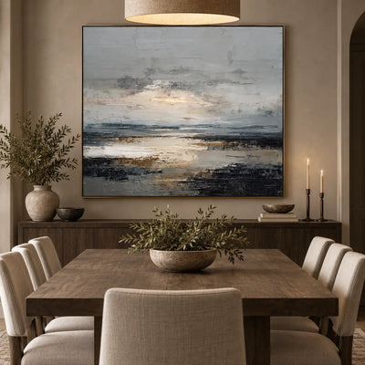 Light Between the Tidal Rocks: behind a wood dining table with cream chairs and two candlesticks