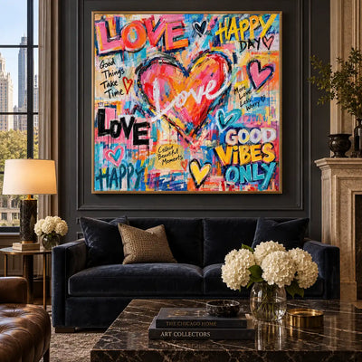 Love in the Middle of Happy: artwork above a navy sofa on dark paneling beside a fireplace