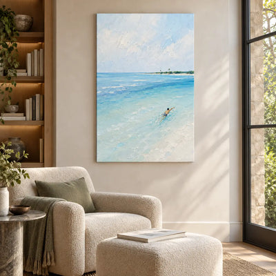 One Stroke Toward the Palms: above a cream reading chair and matching ottoman beside wood shelves